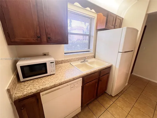 a kitchen with stainless steel appliances granite countertop a refrigerator stove a sink and dishwasher