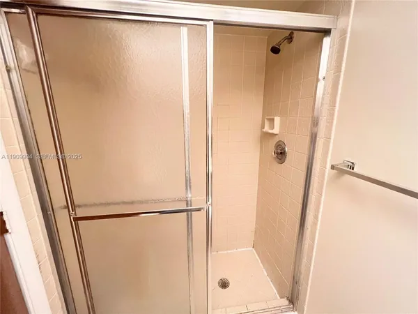 a bathroom with a glass shower door