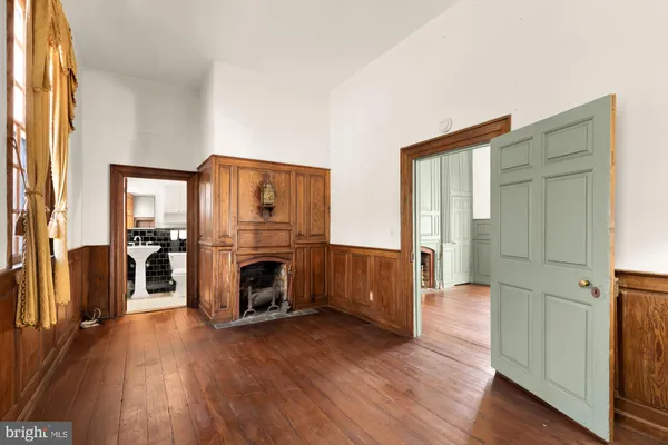 a view of a livingroom with furniture window wooden floor and a fireplace