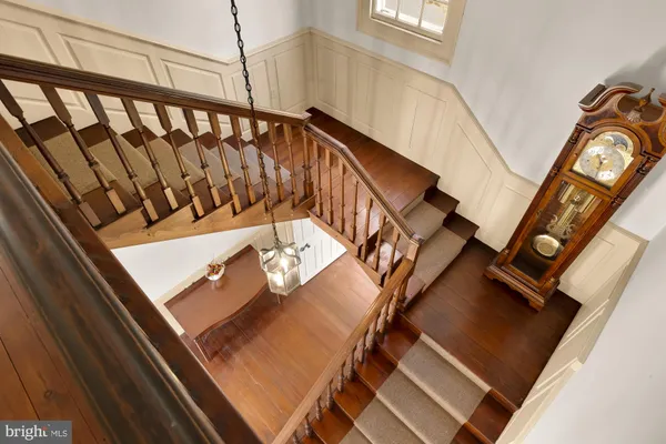 a view of a livingroom with wooden floor and furniture