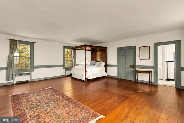 a bedroom with a bed and a table with fireplace