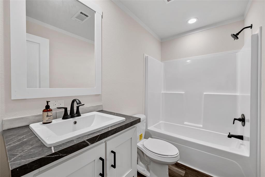 3050 Clater Powell Road Waco, TX 76705 - Photo 29 of 39 a bathroom with a sink a toilet and shower