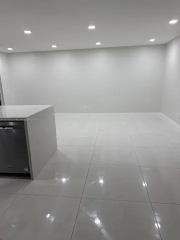 a white toilet sitting next to a white sink and vanity
