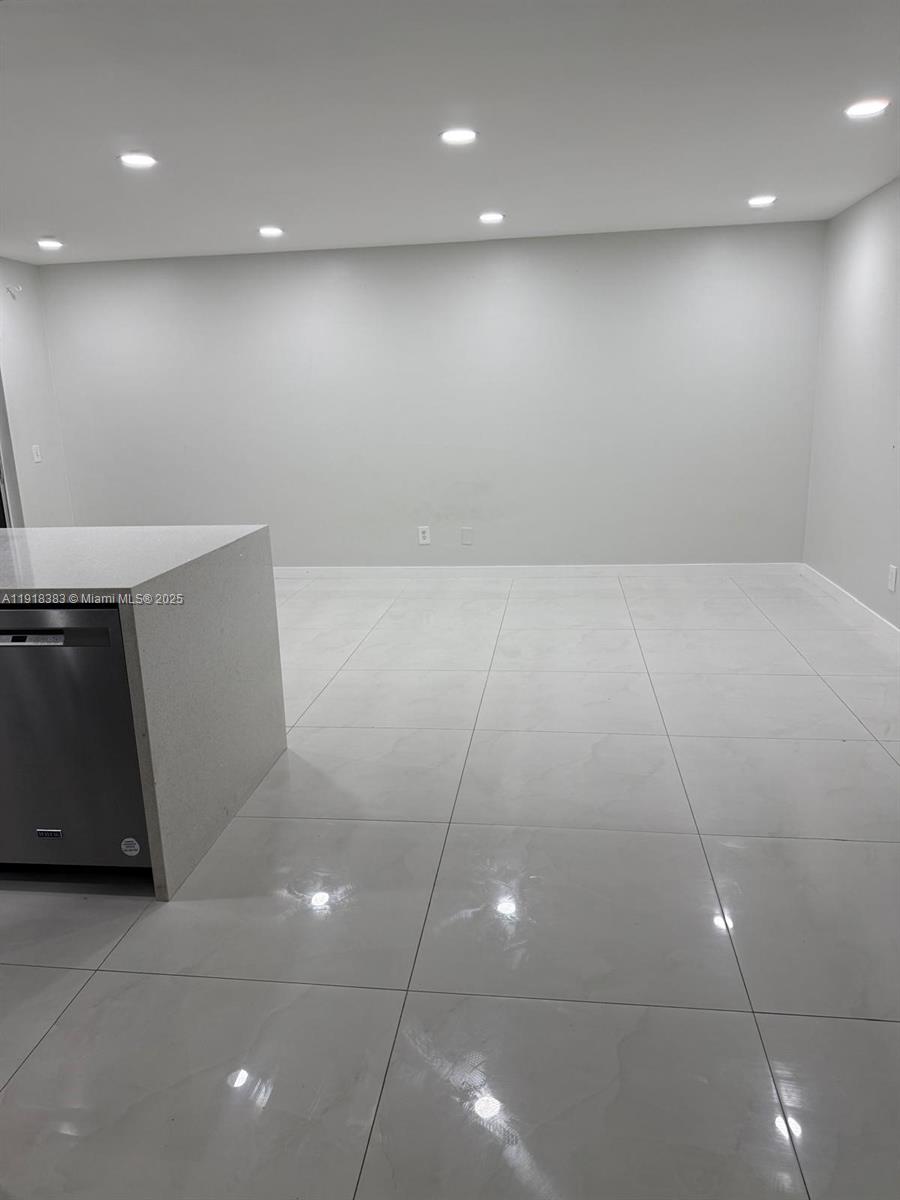 2461 Southwest 82nd Avenue, Unit 105 Davie, FL 33324 - Photo 16 of 17 a view of an empty room with wooden floor