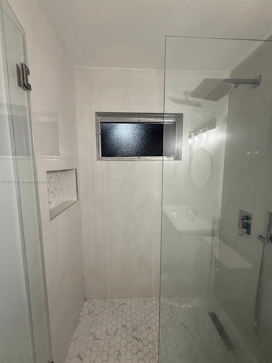 2461 Southwest 82nd Avenue, Unit 105 Davie, FL 33324 - Photo 2 of 17 a bathroom with a shower and a television