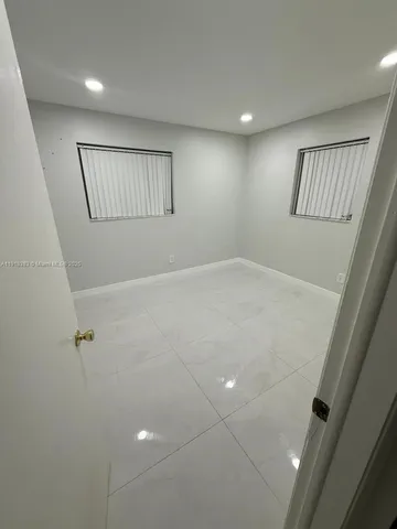 a view of an empty room with windows