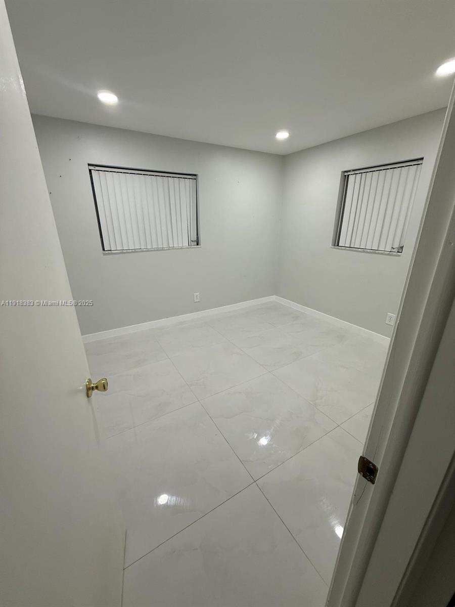 2461 Southwest 82nd Avenue, Unit 105 Davie, FL 33324 - Photo 3 of 17 a view of an empty room with windows