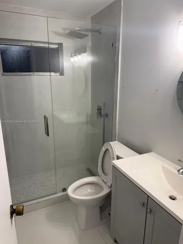a bathroom with a sink mirror and toilet