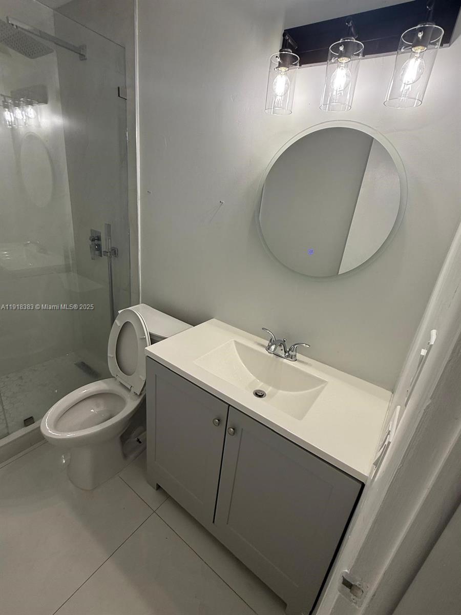 2461 Southwest 82nd Avenue, Unit 105 Davie, FL 33324 - Photo 6 of 17 a bathroom with a sink mirror and toilet