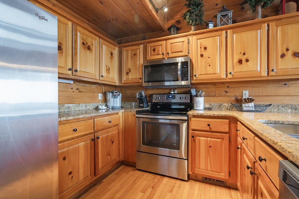 472 Timber Ridge Blue Ridge, GA 30513 - Photo 19 of 63 a kitchen with stainless steel appliances granite countertop a stove a sink and a microwave