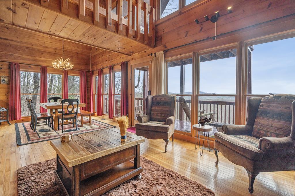 472 Timber Ridge Blue Ridge, GA 30513 - Photo 23 of 63 a living room with furniture a table and large windows