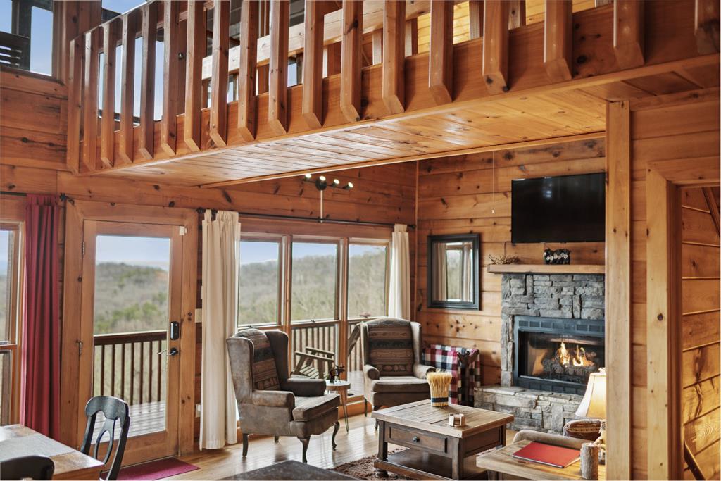 472 Timber Ridge Blue Ridge, GA 30513 - Photo 25 of 63 a living room with fireplace furniture and a flat screen tv