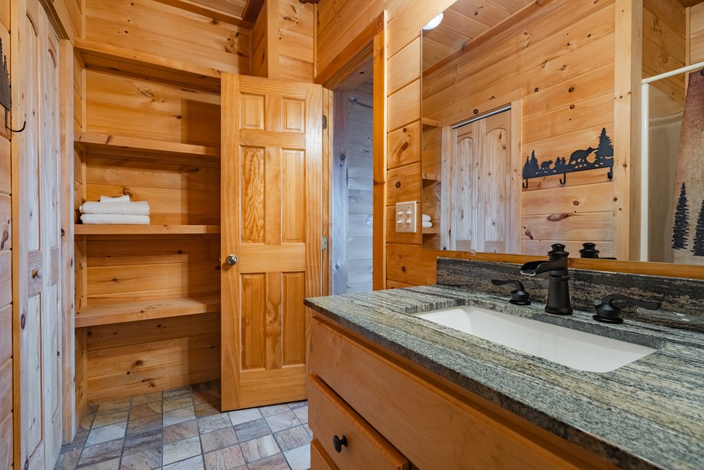 472 Timber Ridge Blue Ridge, GA 30513 - Photo 49 of 63 a bathroom with a granite countertop sink and a mirror