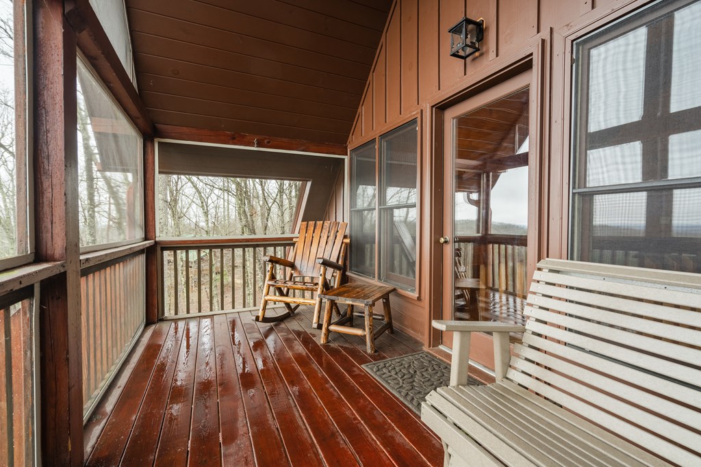 472 Timber Ridge Blue Ridge, GA 30513 - Photo 53 of 63 a view of a balcony with chairs and wooden floor