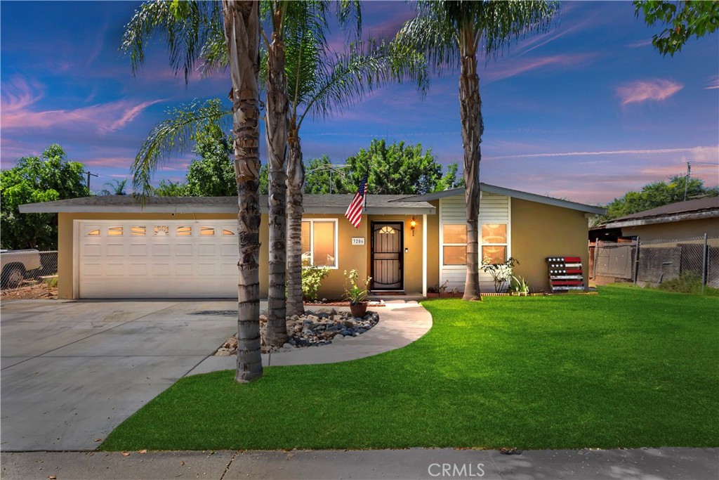 3206 Vance Street Riverside, CA 92504 - Photo 1 of 1 a view of a patio with a table and chairs under an umbrella