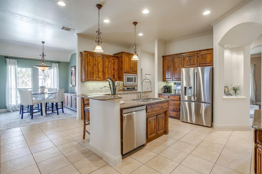 43 Crown Road Willow Park, TX 76087 - Photo 11 of 40 a kitchen with stainless steel appliances granite countertop a stove a sink a refrigerator and a refrigerator