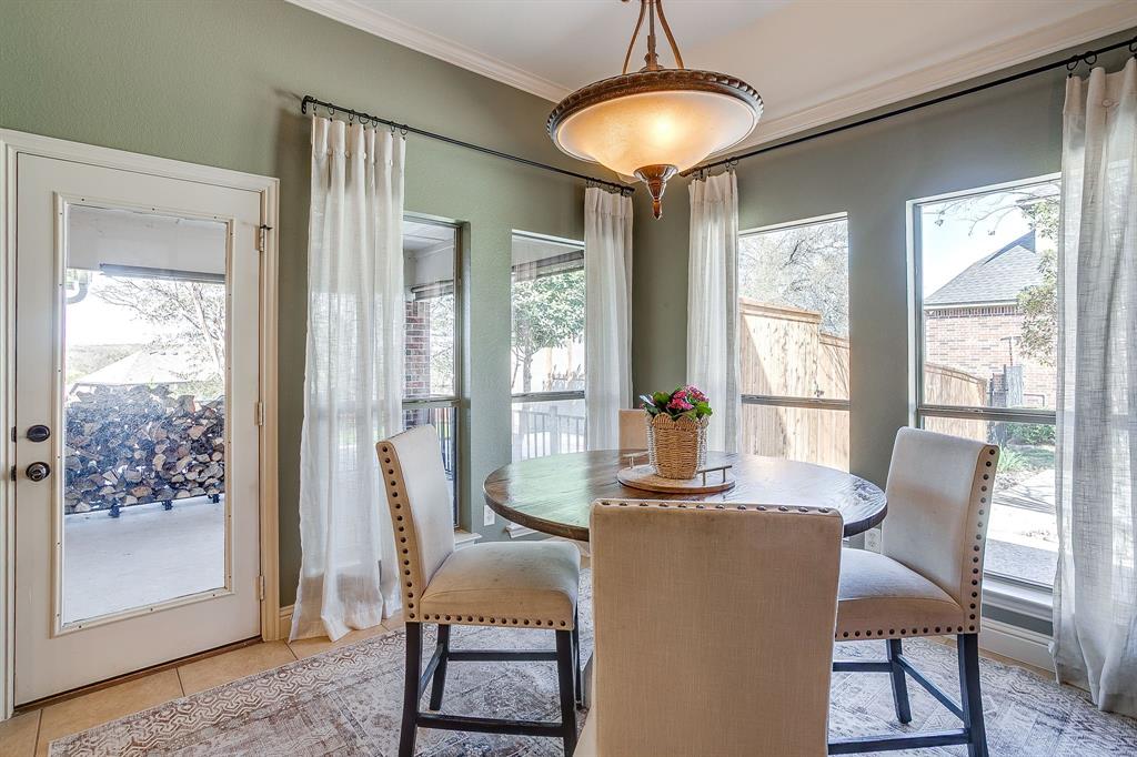 43 Crown Road Willow Park, TX 76087 - Photo 13 of 40 a dining room with furniture a chandelier and wooden floor