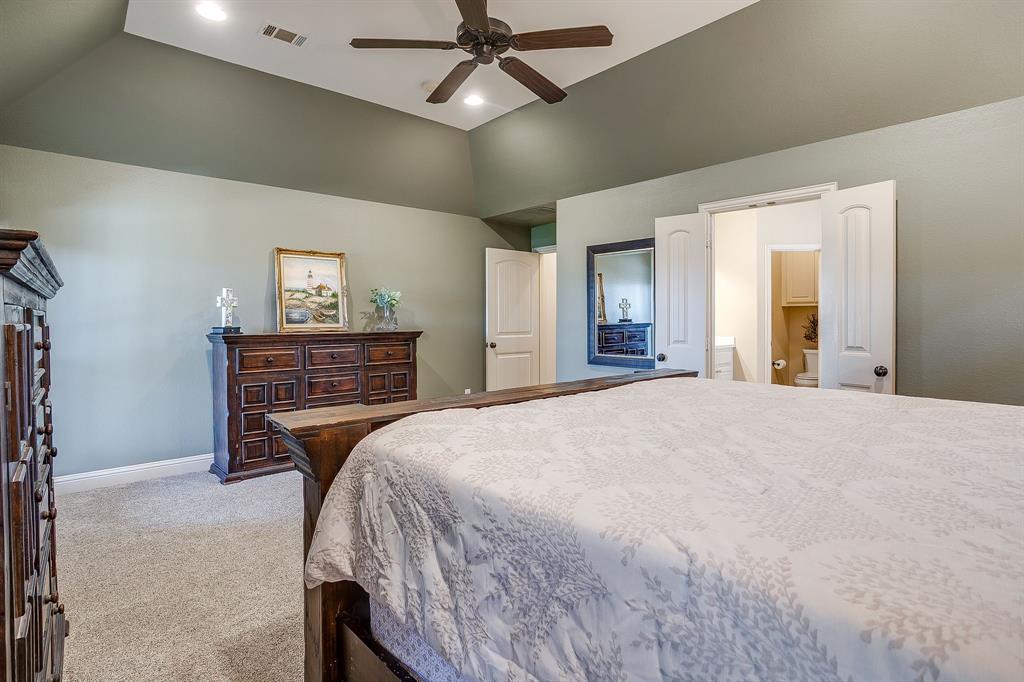 43 Crown Road Willow Park, TX 76087 - Photo 19 of 40 a bedroom with a bed and a chandelier