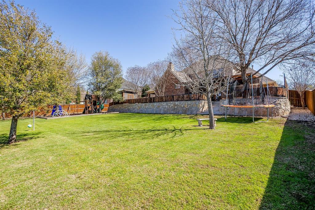 43 Crown Road Willow Park, TX 76087 - Photo 37 of 40 a view of a swimming pool with a house in the background