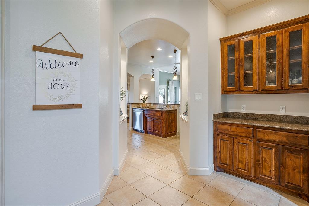 43 Crown Road Willow Park, TX 76087 - Photo 6 of 40 a view of a kitchen with stainless steel appliances wooden floor and cabinets
