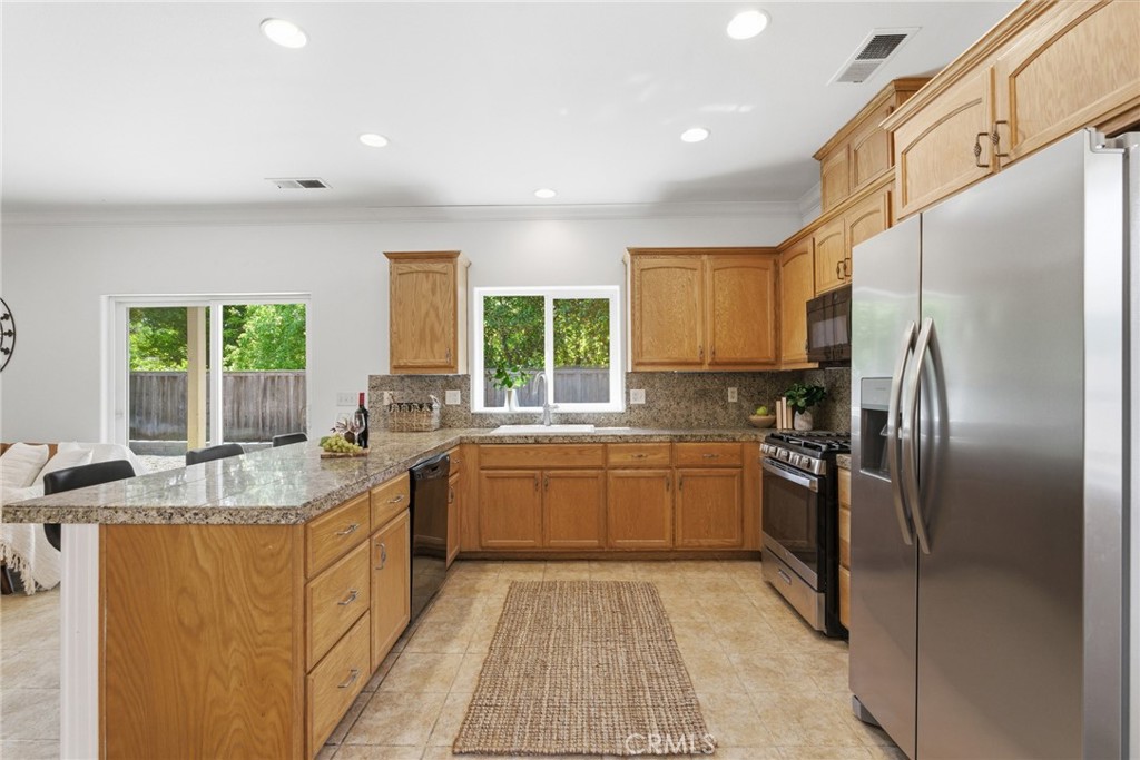 451 Hideaway Chico, CA 95926 - Photo 13 of 33 a kitchen with stainless steel appliances granite countertop a sink stove and refrigerator