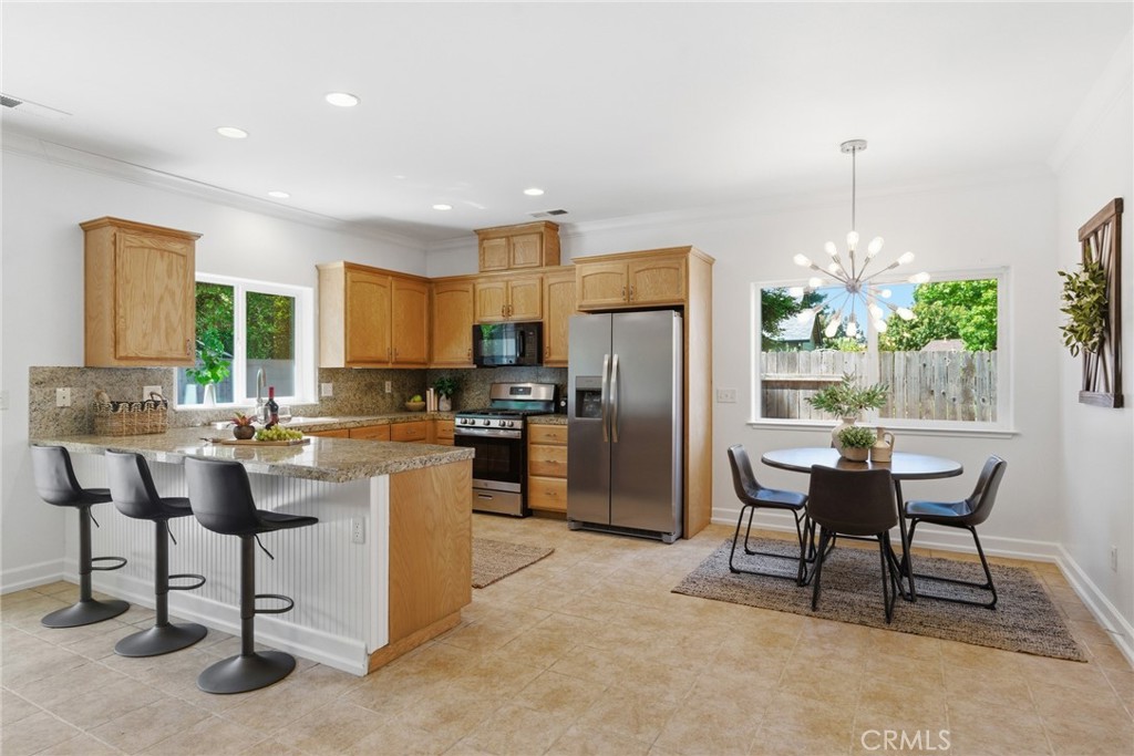 451 Hideaway Chico, CA 95926 - Photo 4 of 33 a kitchen with a refrigerator a dining table and chairs