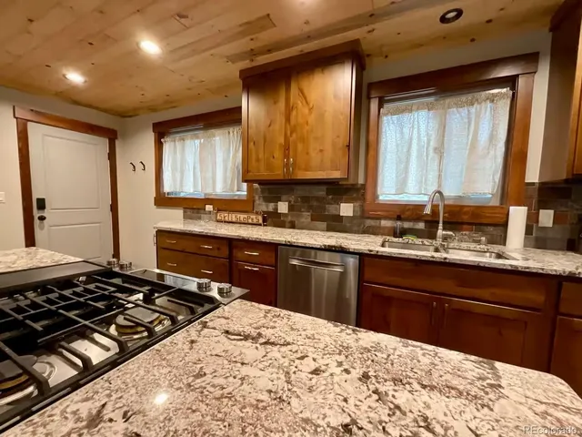 a kitchen with a sink stove and cabinets