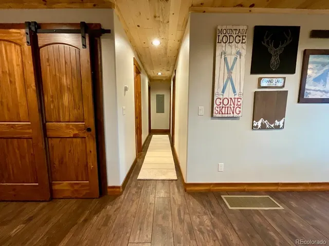 a view of a hallway with wooden floor