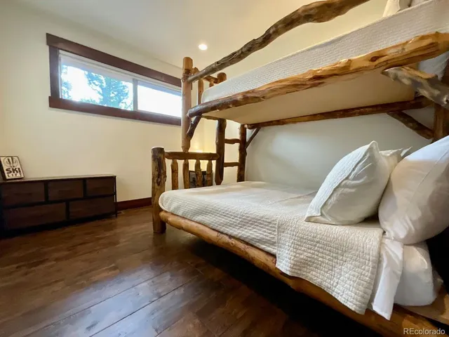 a bedroom with a bed next to a window