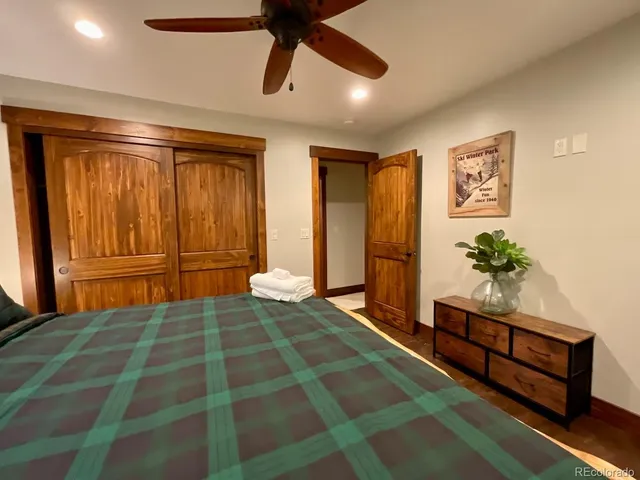 a spacious bedroom with a bed and a chandelier