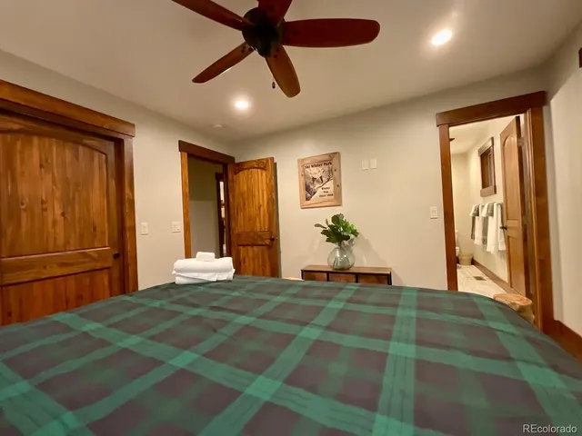 a bedroom with a large bed and a chandelier