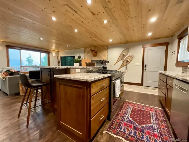 a kitchen with kitchen island granite countertop lots of counter top space and a sink