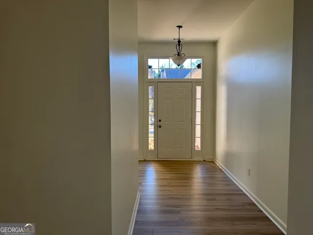 a view of a hallway with wooden floor