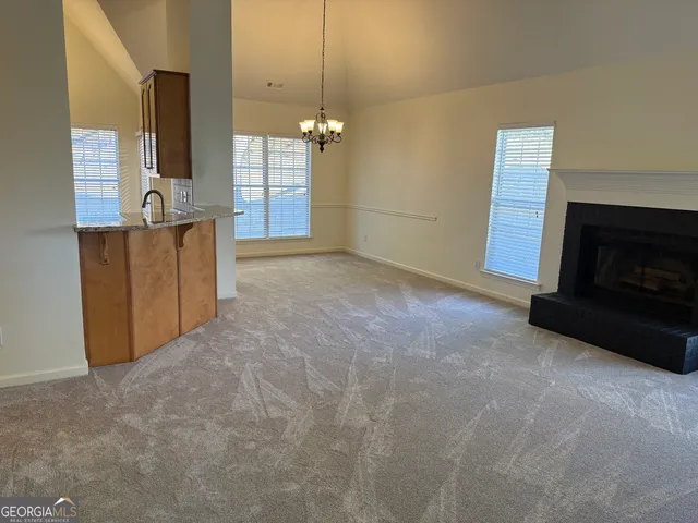 a view of a kitchen with a sink and a fireplace