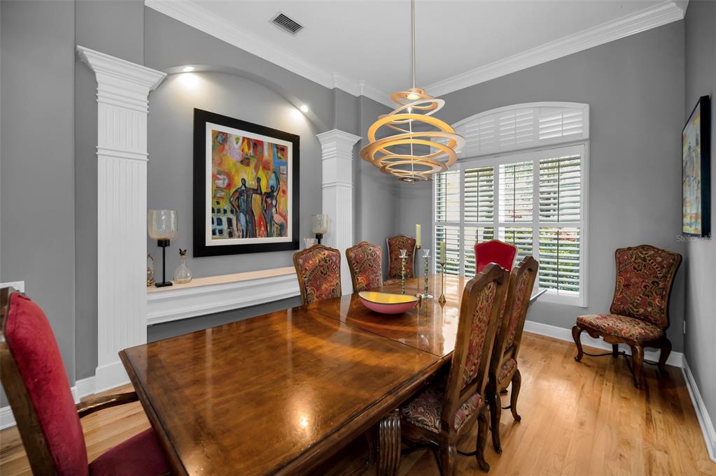 8871 Silverthorn Road Seminole, FL 33777 - Photo 20 of 98 a view of a dining room with furniture wooden floor and chandelier