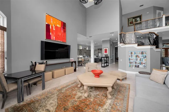 a living room with furniture and a floor to ceiling window