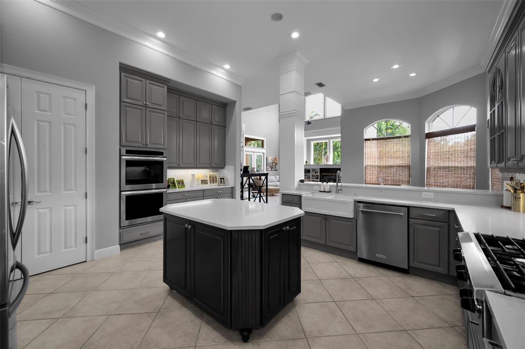 8871 Silverthorn Road Seminole, FL 33777 - Photo 36 of 98 a kitchen with kitchen island granite countertop a sink counter top space appliances and a window