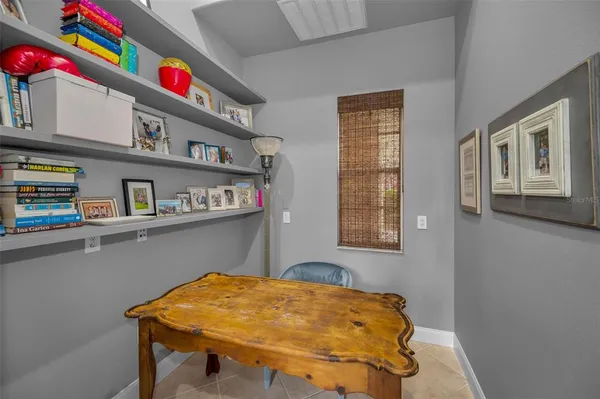 a spacious bedroom with a bed and a ceiling fan