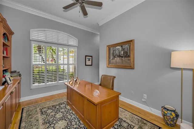 a view of a hallway with wooden floor and stairs