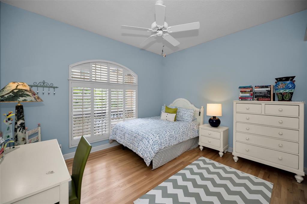 8871 Silverthorn Road Seminole, FL 33777 - Photo 76 of 98 a bedroom with a bed and a dresser