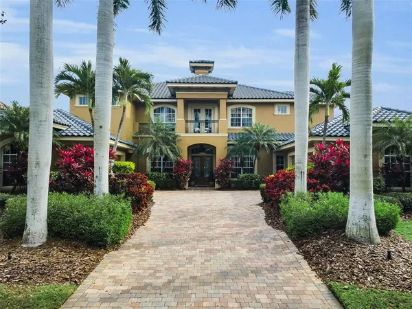 a view of a dining room with furniture wooden floor and chandelier