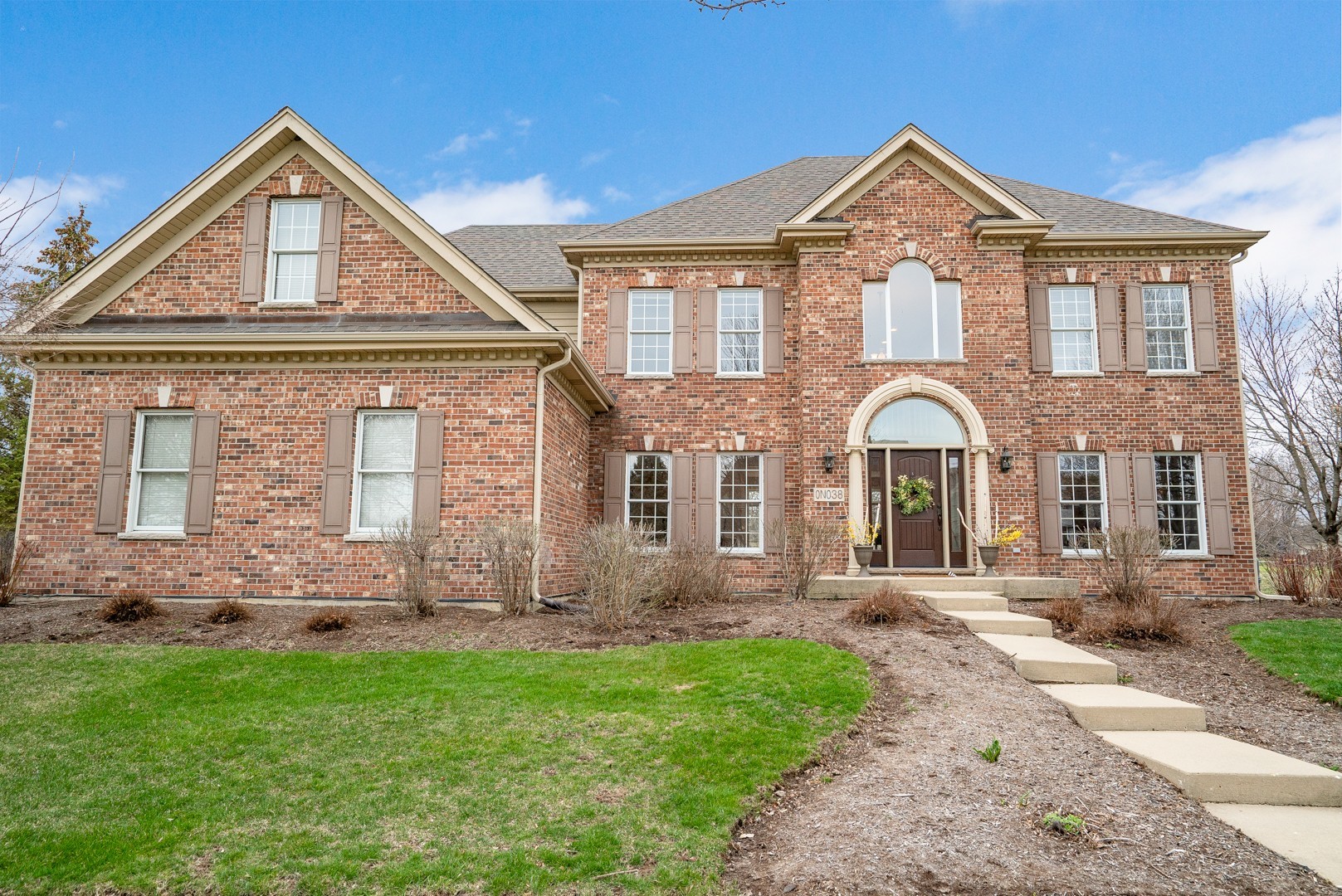 a front view of a house with a yard