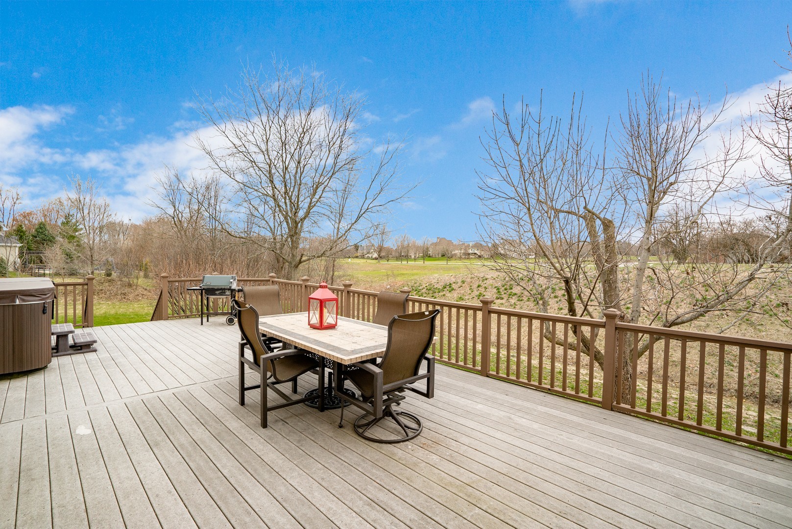 Undisclosed Address Geneva, IL 60134 - Photo 29 of 29 a view of a roof deck with table and chairs with wooden floor and fence