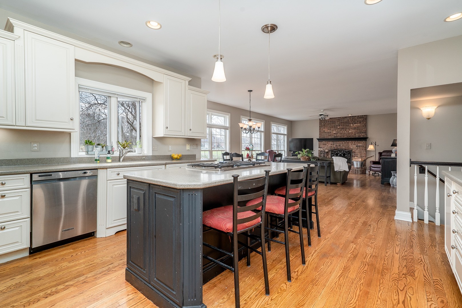 Undisclosed Address Geneva, IL 60134 - Photo 7 of 29 a kitchen with stainless steel appliances granite countertop a stove a sink dishwasher a microwave oven and a dining table with wooden floor