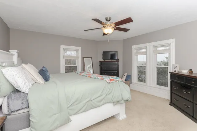 a bedroom with a bed and a tv