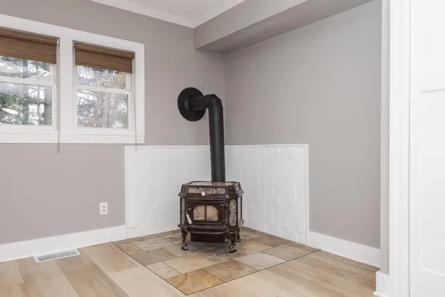 a view of a dining room and livingroom with furniture wooden floor a chandelier