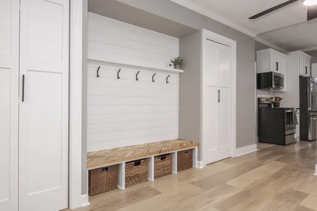a kitchen with granite countertop sink cabinets and wooden floor