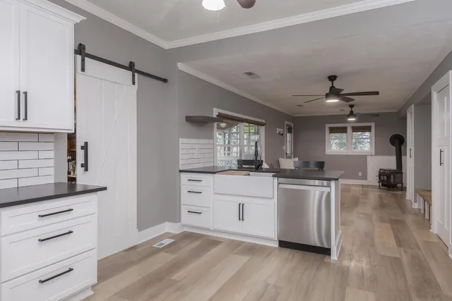 a kitchen with kitchen island stainless steel appliances a sink and a refrigerator