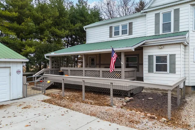 a view of a house with a yard and wooden fence