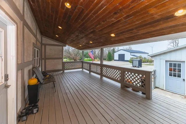 a view of a porch with wooden floor and fence